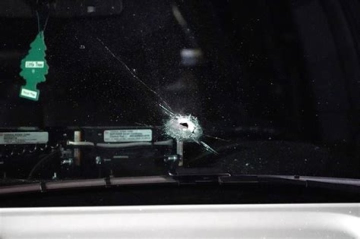 	BULLET STRIKES WINDSHIELD OF AUTO	