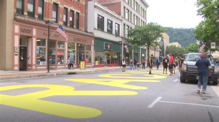 Volunteers paint the words 